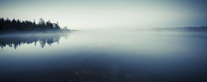 Quiet lake before dawn in the mist